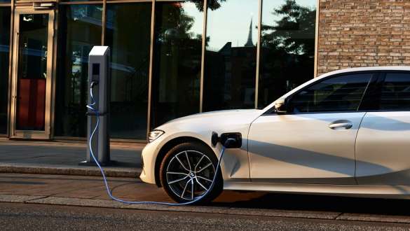 Plug-in hybrid BMW 3 Series Sedan 2021 G20 side view Plug-in hybrid BMW 3 Series Sedan 2021 G20 side view on charging station