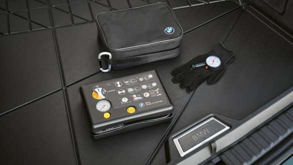 BMW tyre mobility set Opened BMW tyre mobility set in front of a BMW wheel