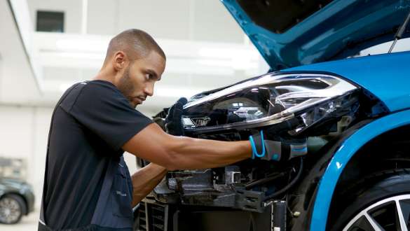 BMW specialist is polishing car BMW Repair & Care BMW specialist is polishing car
