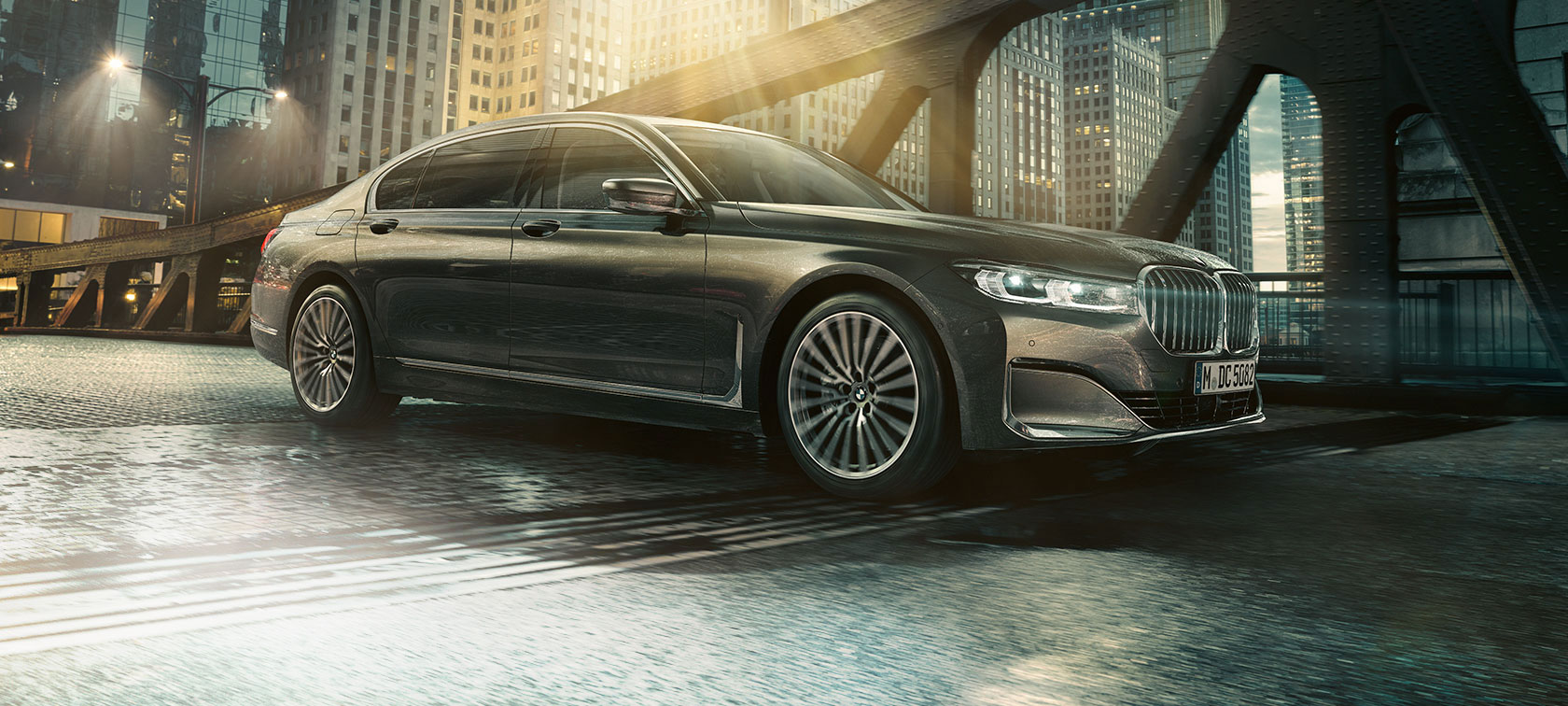 BMW 7 Series Sedan side view G11 BMW 7 Series Sedan in side view with opened door in front of illuminated hotel G11