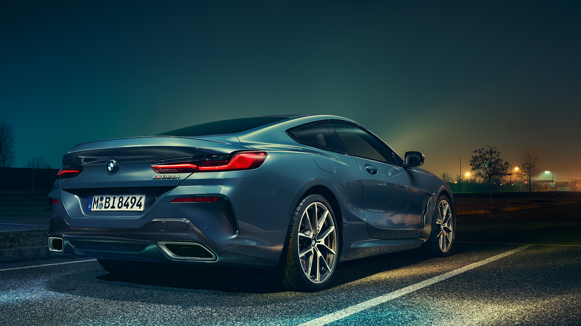 BMW 8 Series Coupé, three-quarter rear view. G15 BMW 8 Series Coupé, three-quarter rear view, standing in front of night scenery. G15
