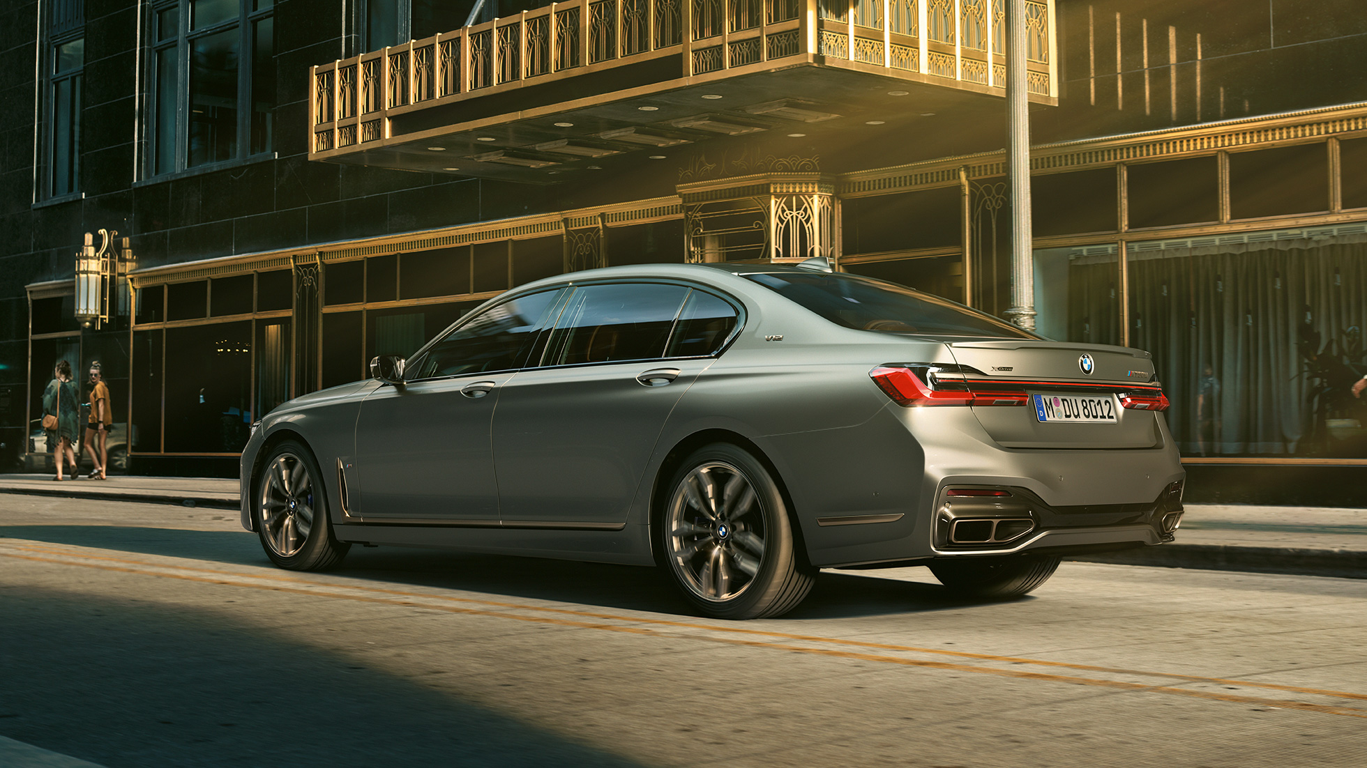 BMW M760Li xDrive Sedan with V12 engine BMW M760Li xDrive Sedan, lateral rear view in front of skyscrapers in urban setting