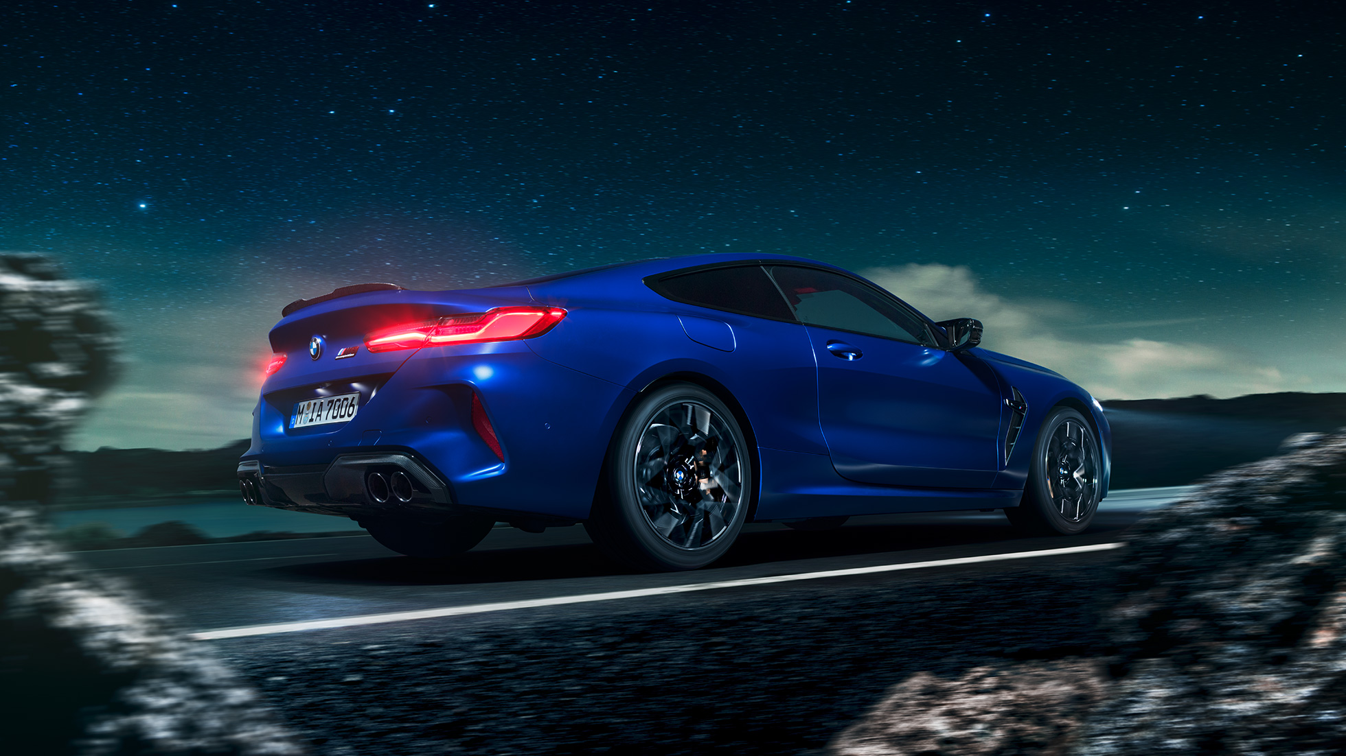 BMW M8 Competition Coupé, three-quarter side view. F92 BMW M8 Competition Coupé in Marina Bay Blue metallic, driving three-quarter side view in front of starry sky. F92