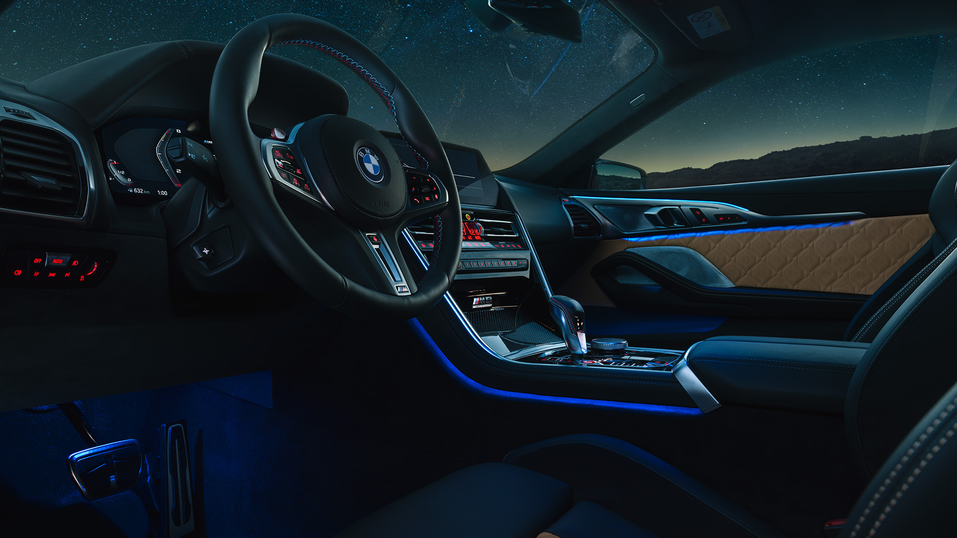 BMW M8 Competition Coupé, cockpit. F92 BMW M8 Competition Coupé, cockpit at night with M leather steering wheel and blue ambient light. F92