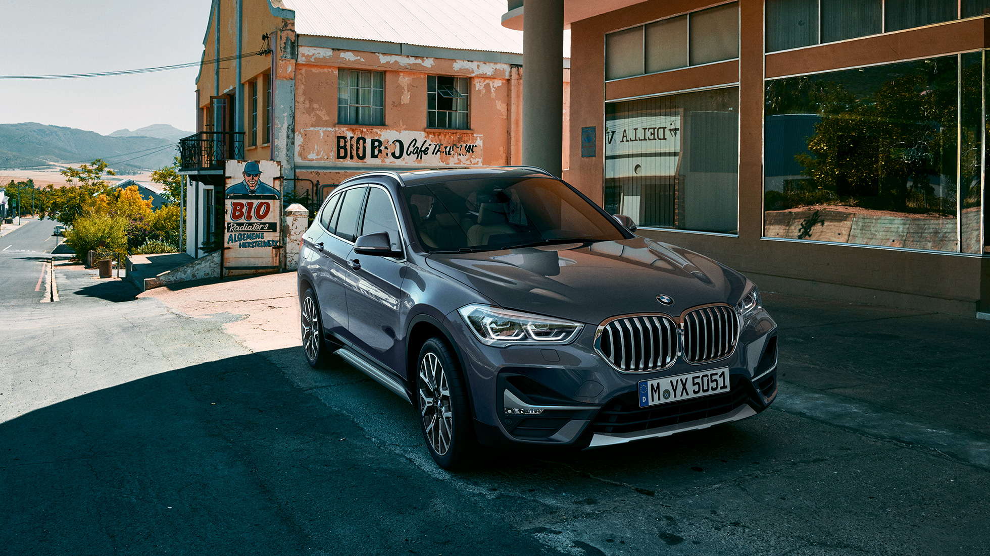 BMW X1, three-quarter front view. F48 BMW X1, three-quarter front view standing in front of urban scenery. F48