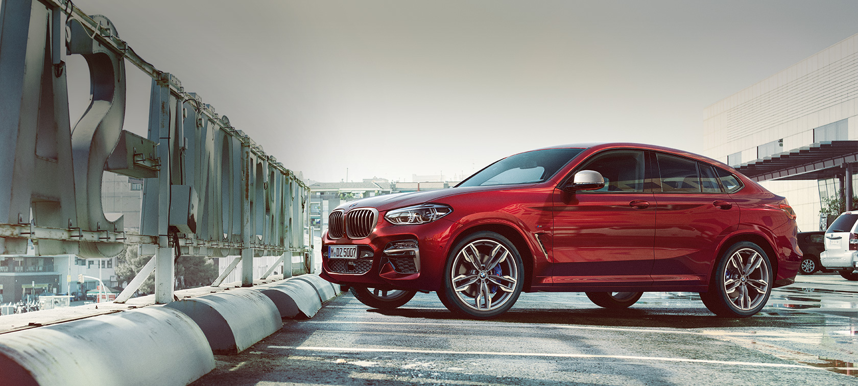 Parking side view BMW X4 G02 BMW X4 M40i G02 2018 Flamenco Red brilliant effect side view parking on parking deck