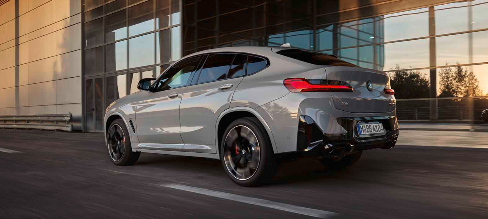 BMW X4 G02 three-quarter rear view driving 2021 BMW X4 G02 three-quarter rear view driving 2021