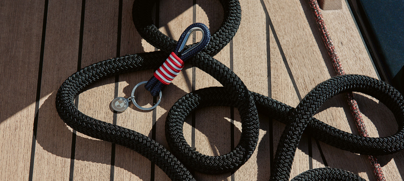 BMW Yachtsport Keyring. A BMW Yachtsport Keyring from the BMW Yachtsport Collection is shown lying on wooden decking.
