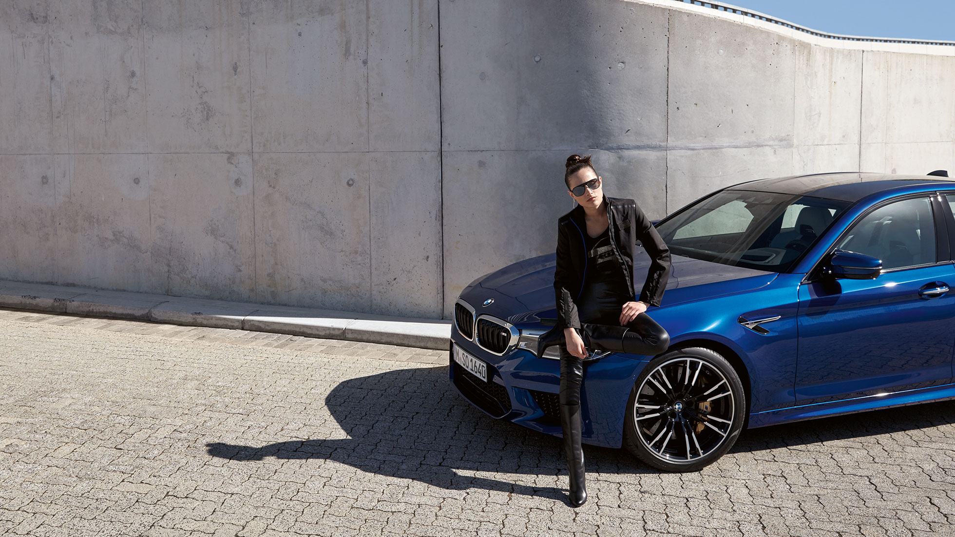 BMW M Collection. A young woman is shown wearing a BMW M Jacket for women.