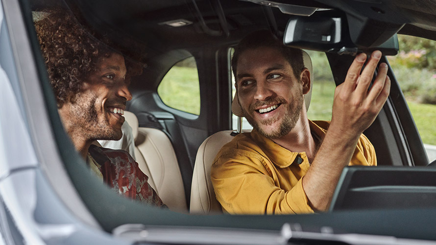 Men laughing and sitting in BMW BMW Financial Services men laughing and sitting in BMW