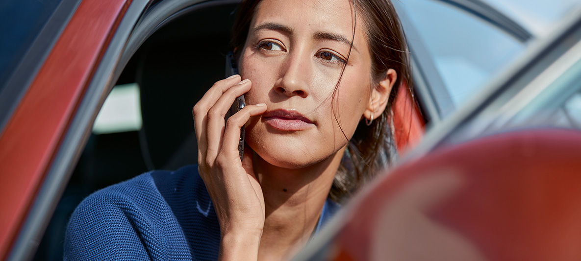 A woman getting out of her BMW whilst on the phone. A woman getting out of her BMW whilst on the phone.