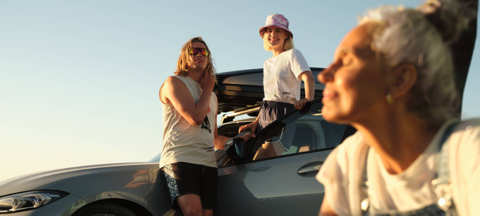 Original BMW Summer Accessories and Care Products BMW X1 U11 Original BMW Summer Accessories and Care Products BMW X1 U11 standing with three women in sunlight