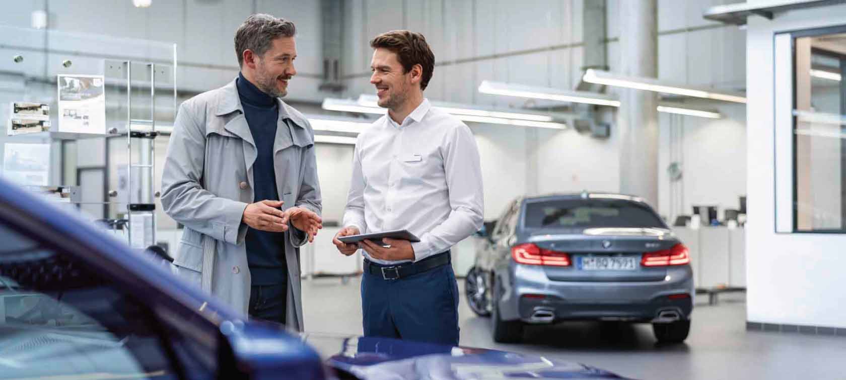 A man sensitively touching his BMW. A man sensitively touching his BMW.