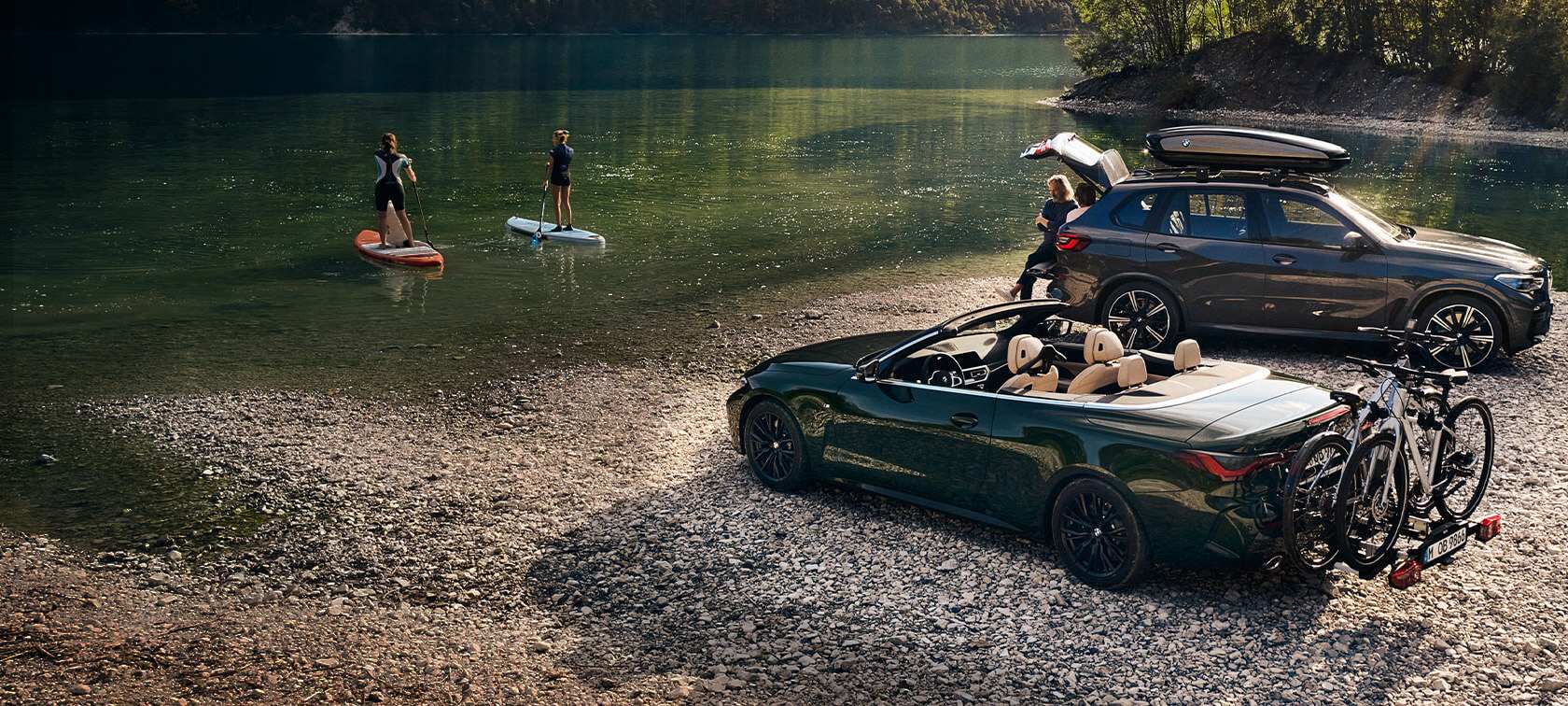 BMW vehicles in front of lake and green landscape BMW Spring Summer Accessories BMW vehicles in front of lake and green landscape