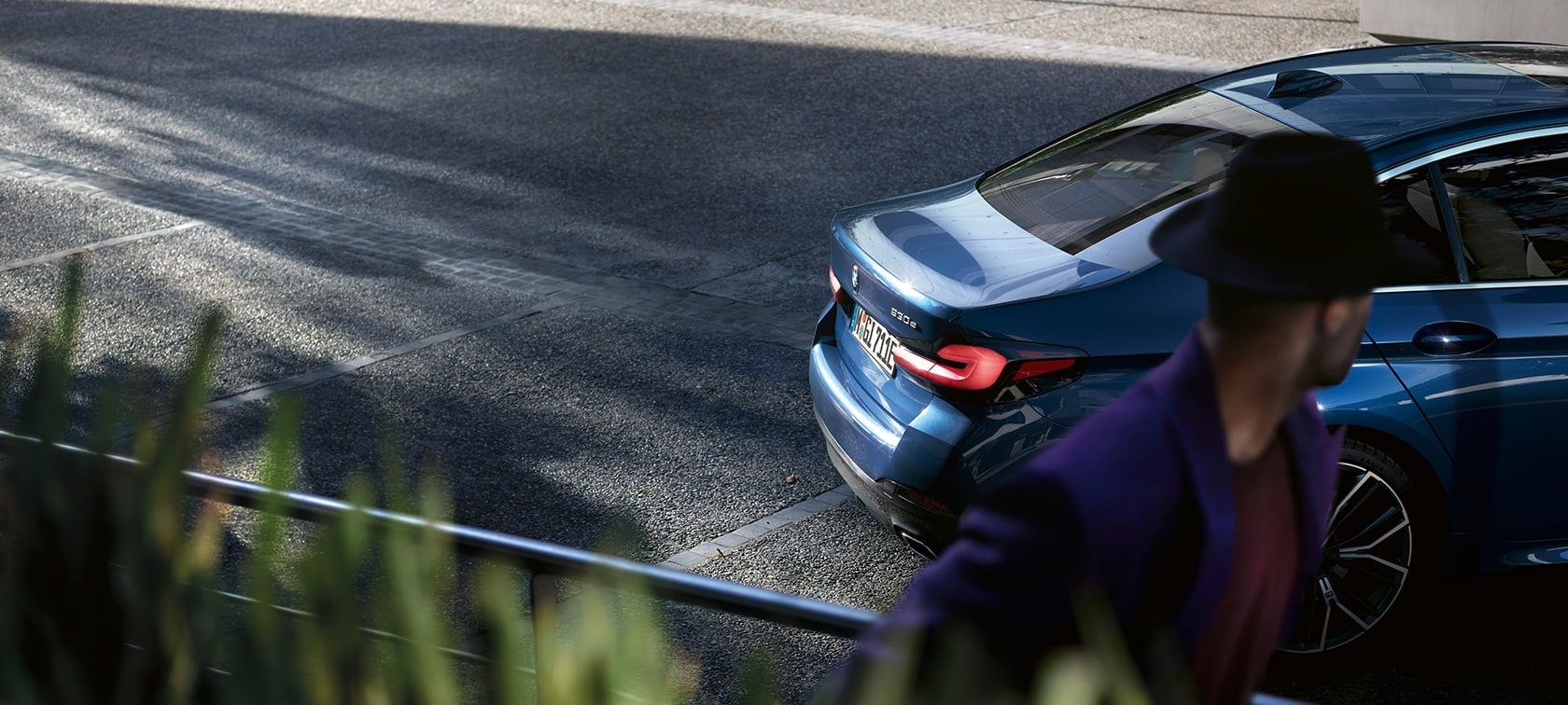 Man standing behind parking BMW BMW 5 Series Sedan G30 BMW 5 Series Sedan G30 Facelift 2020 man standing behind parking BMW