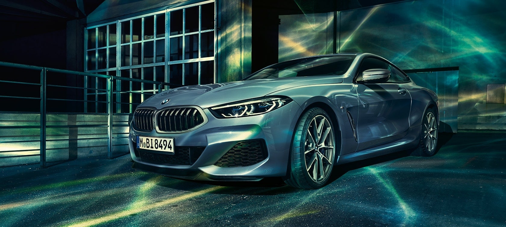 The BMW 8 Series Coupé, three-quarter front shot. G15 The BMW 8 Series Coupé, three-quarter front shot, in front of industry building. G15