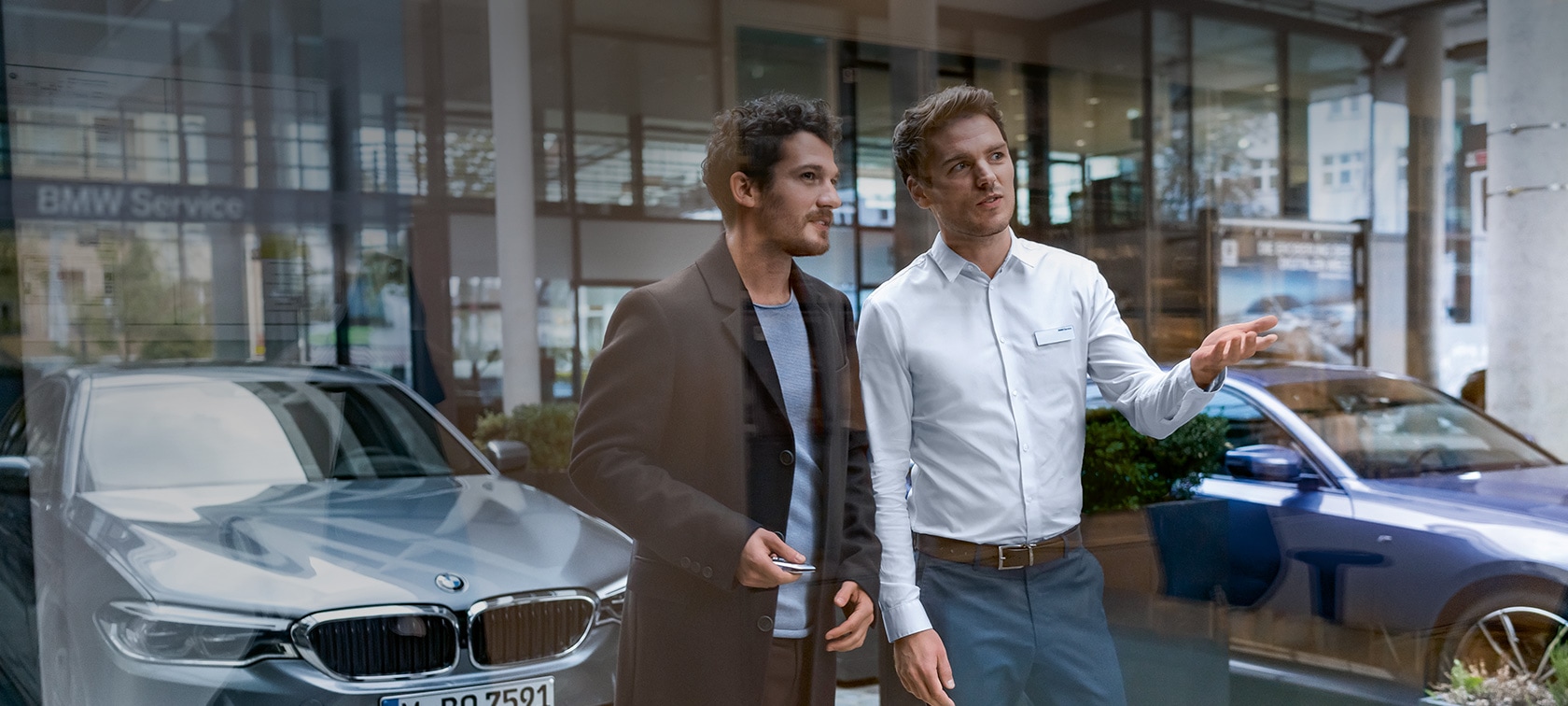 BMW Service BMW Service BMW dealer and BMW customers stand in front of BMW workshop